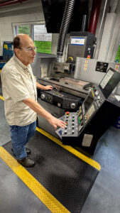 Manufacturing employee operating CNC grinding equipment in the Ripley Tools production facility.